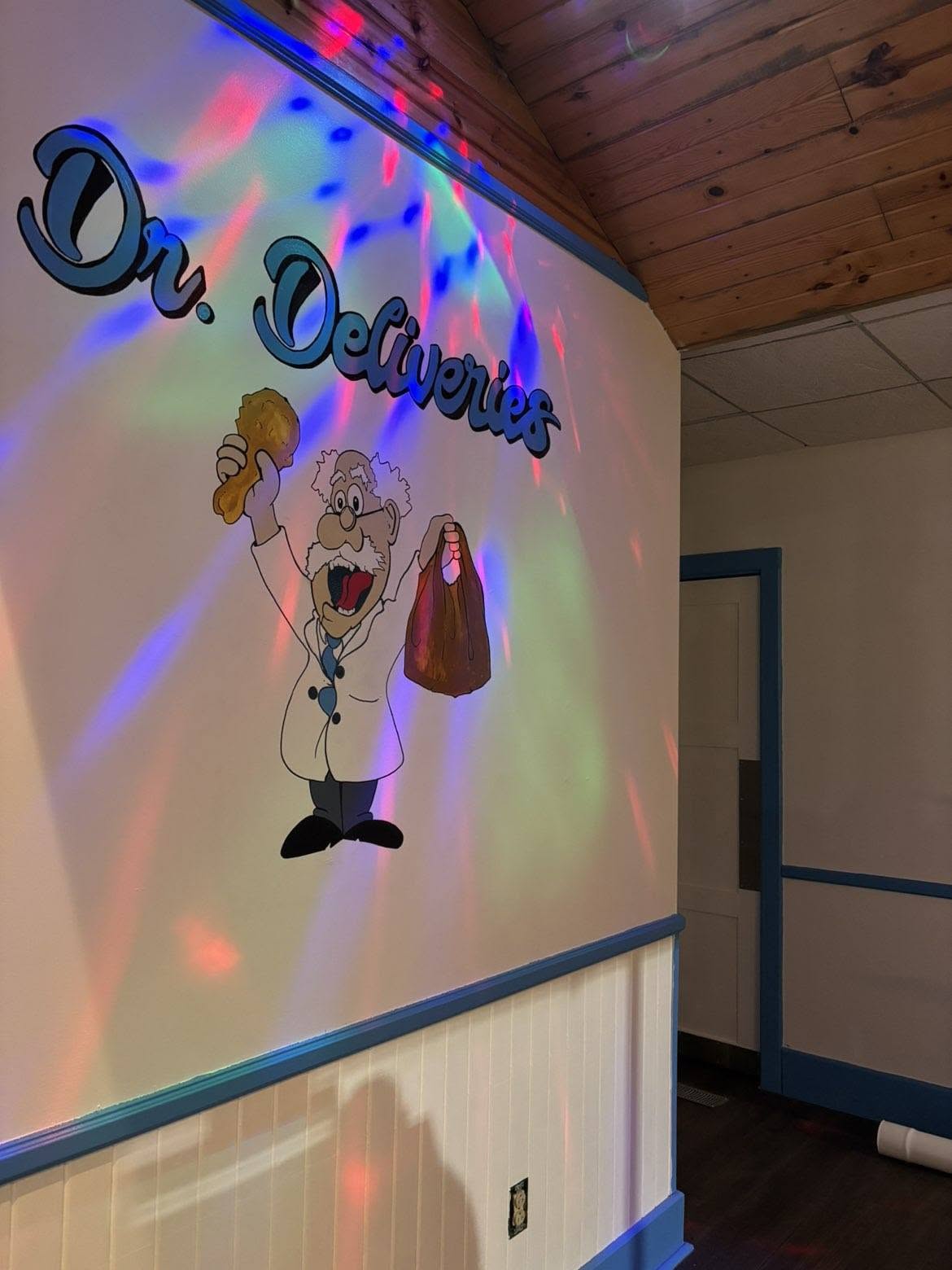 Dr. Deliveries waiting area with mural