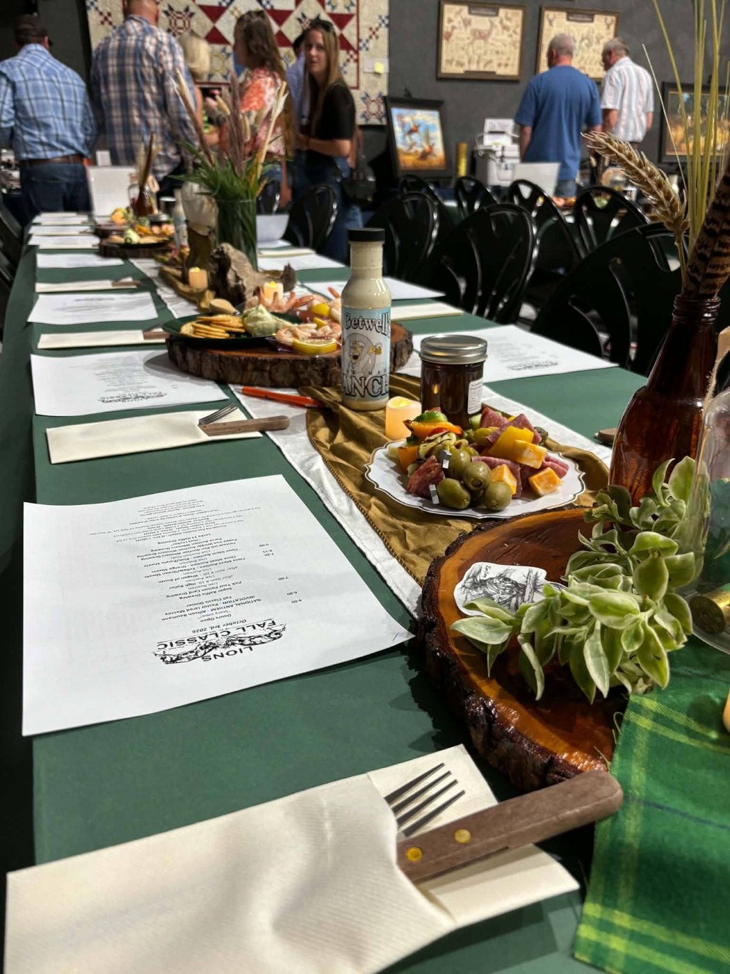 Banquet tables set with green linens, charcuterie, shrimp and Getwell's ranch at the Lions Club Fall Classic