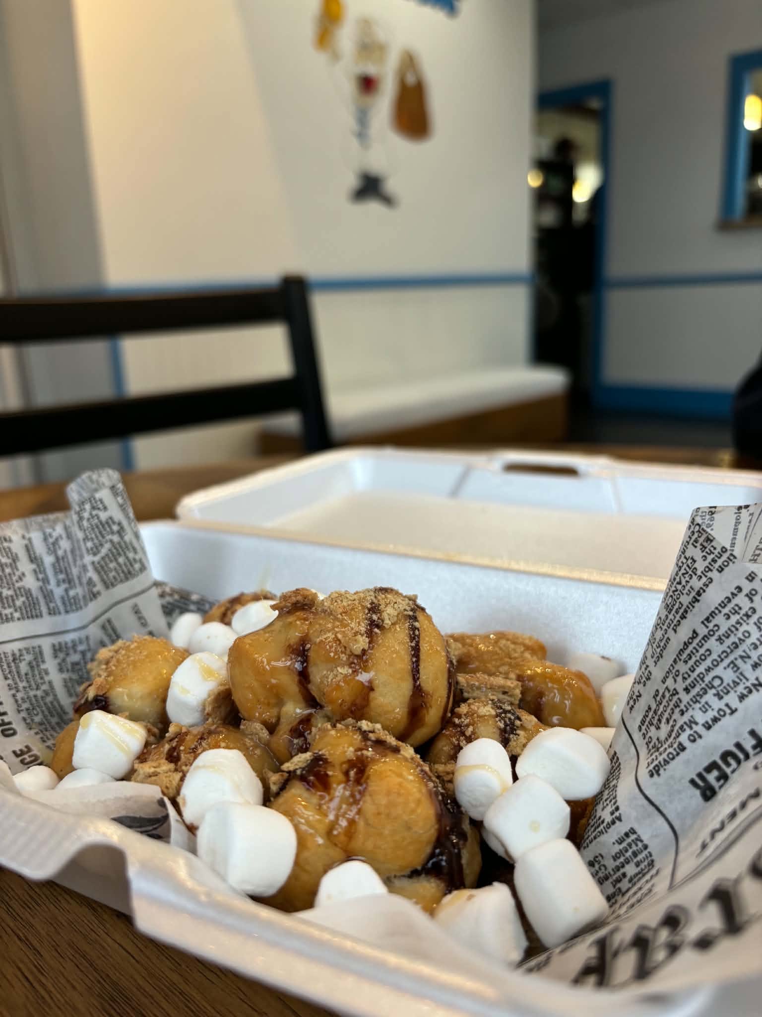 Loaded donut holes with chocolate drizzle, marshmallows and graham crumbs
