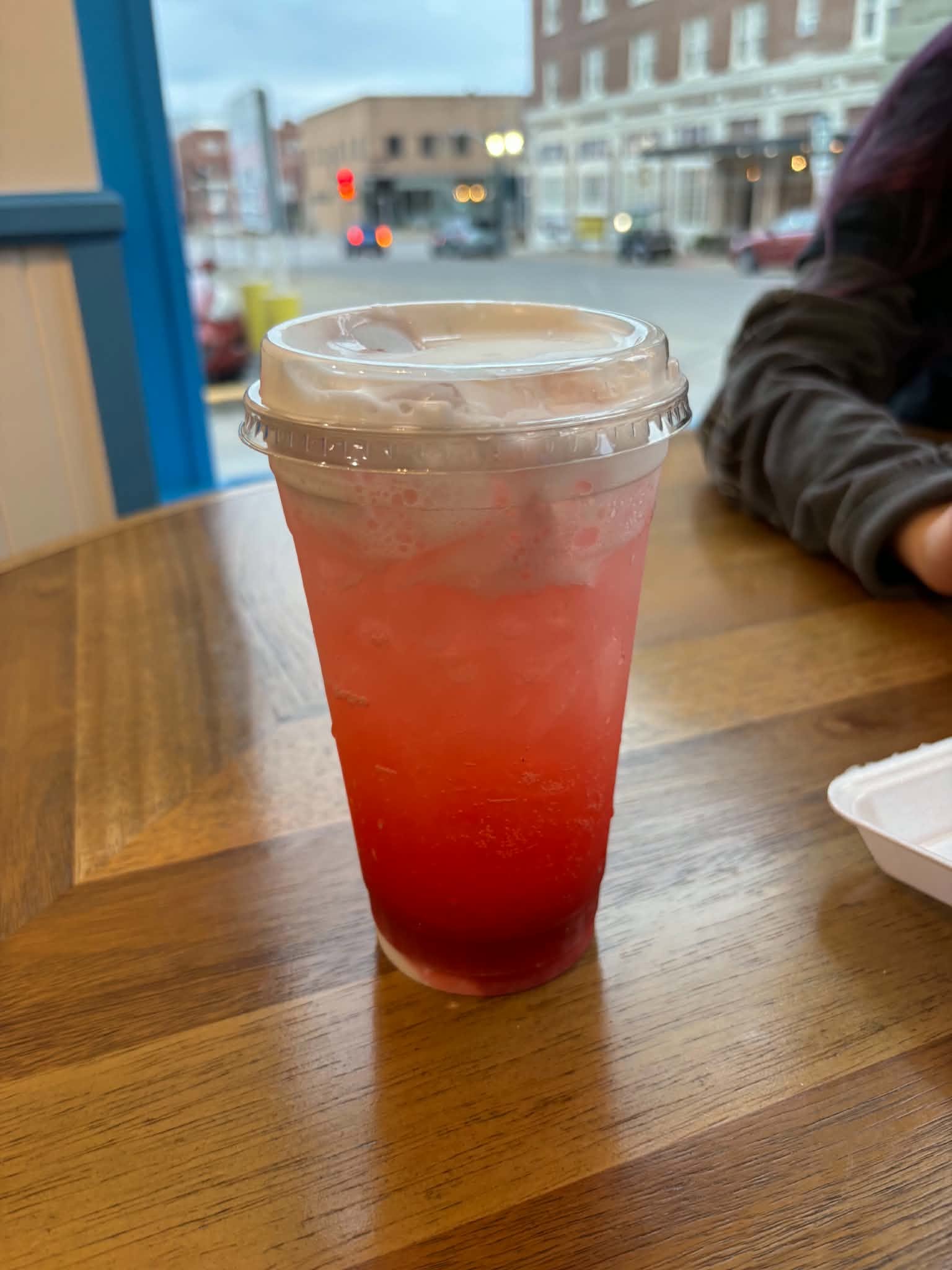 Iced Lotus energy drink in a clear cup by the downtown Keokuk window
